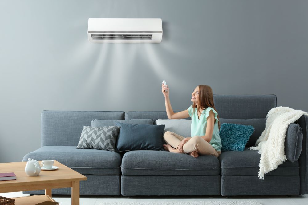 Family relaxing in a home with a Daikin reverse cycle air conditioner.
