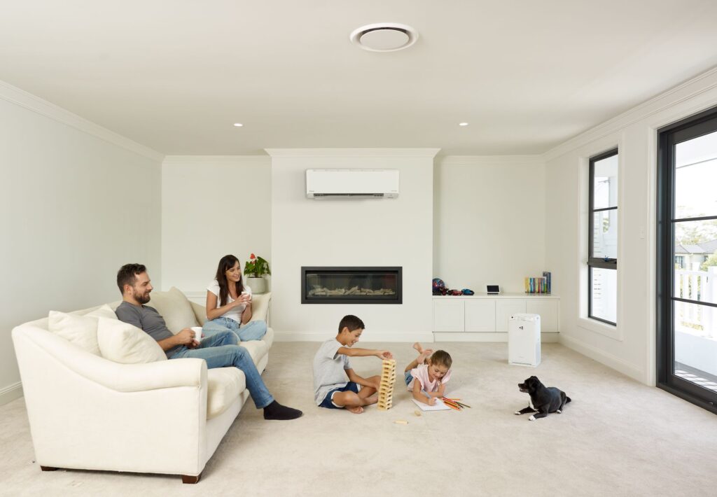 Parents and children enjoying a comfortable home with a Daikin air conditioner.